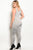 Plus size spandex blend jumpsuit with lace up details along the leg and a v neckline